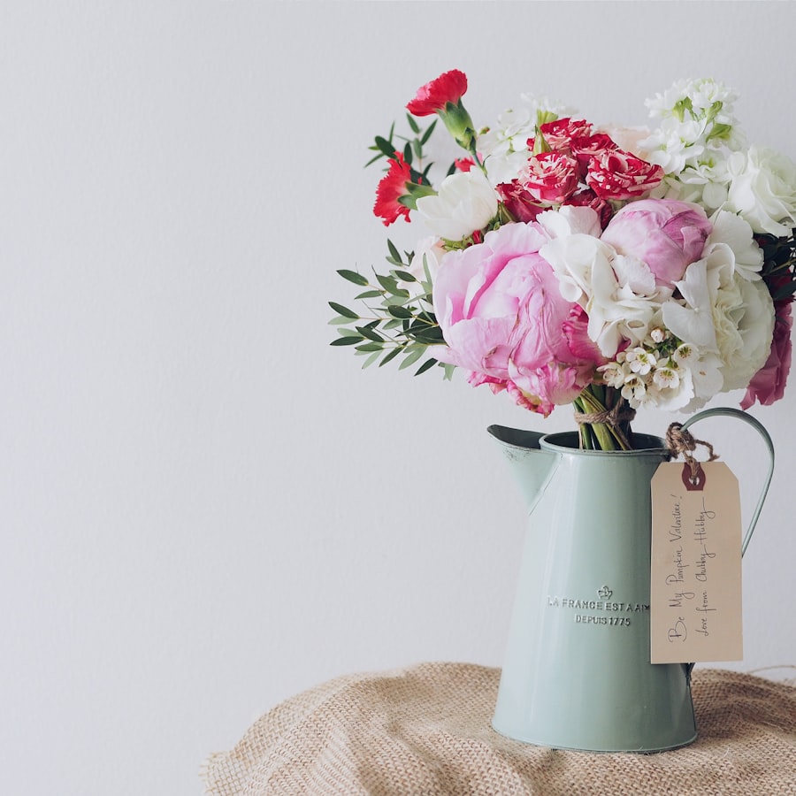 Peonies and carnations arranged in a vintage pitcher